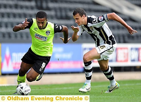 RUNNING BATTLE: Dominic Poleon turns on the turbo in a bid to outstrip his Notts County marker. Pictures: ALAN HOWARTH
