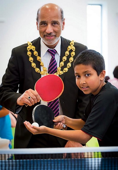 GAME on: Oldham Mayor, Councillor Fida Hussain, plays table tennis with 10-year-old ace and England prospect Amir Hussain