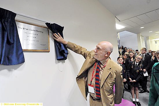 Brian draws the curtain to officially open the school’s new classroom block