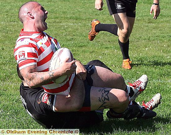 FEELING THE PAIN . . . Oldham’s Brett Robinson was taken off after this tackle.