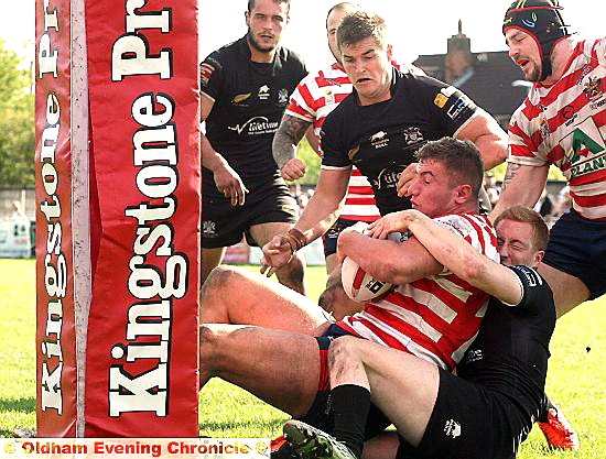 SO CLOSE: Nathan Mason is grabbed on the Gloucester try-line. 