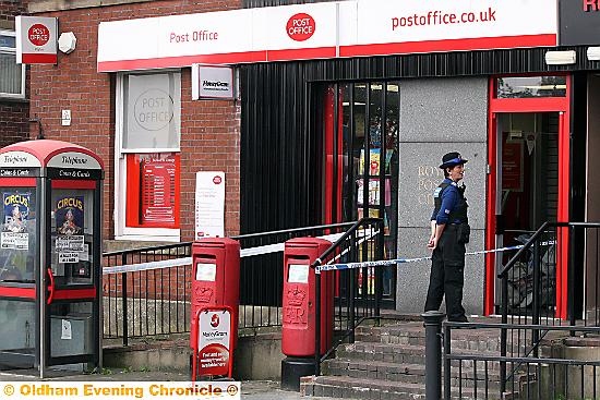 CORDONED off . . . police at the scene of the robbery