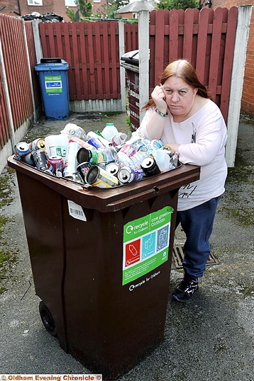 Pamela Kay - with overflowing recycling bin