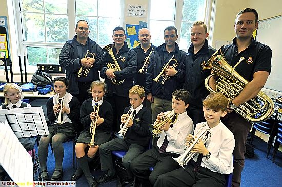 WORKSHOP: The Band of The King’s Division teach pupils. Back, from left, Cpl John Bailey, L/Cpl Perry O’Brien, Cpl Wayne Filer, L/Cpl Martin Leech, L/Cpl John Pearson and Cpl Pete May 