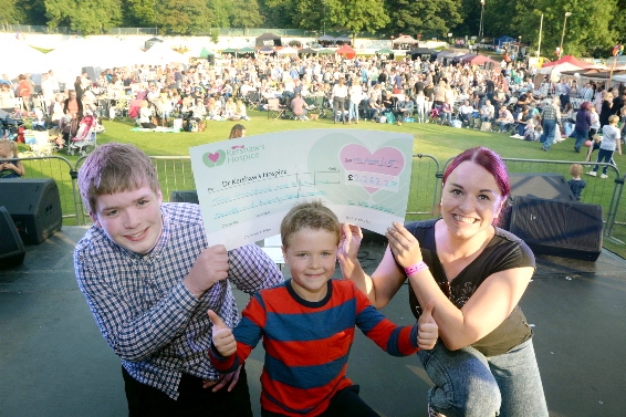 Kieran McNahon presents his cheque to Cole Maxwell (8) and Angela Higham from Dr Kershaws