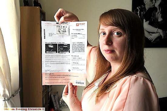 FRUSTRATED . . . Karen Jones with the fine issued by Smart Parking