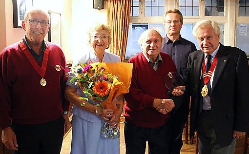 CONGRATULATIONS: Joe, centre, and his wife Doreen with choir president Malcolm Hill, right, and watched by other choir members