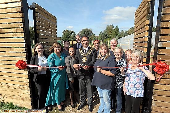 THE Mayor, Councillor Ateeque Ur-Rehman, cuts the ribbon to an open day at the popular Waterhead growing hub