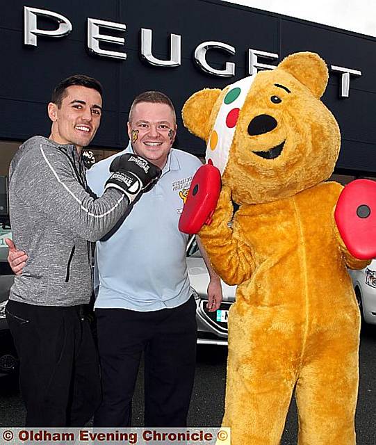 CHARITY knockout ... Chadderton boxer Anthony Crolla, left, with RRG Peugeot Oldham general sales manager Matthew Jordan and Pudsey bear.
