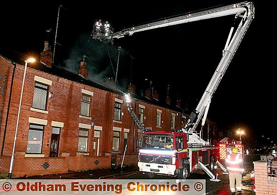 Firemen from Greater Manchester Fire Brigade attend a house fire on, Greenhill road, Chadderton. 