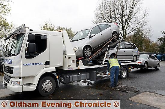 Police and licence enforcement agencies carry out Operation Considerate outside Oldham fire station on Lees Road. Vehicles were stopped for a variety of offences, including driving without insurance and driving while putting on make-up. Pic shows cars being seized for having no insurance.