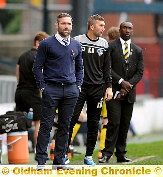 STUDY IN CONCENTRATION: Athletic boss David Dunn (left), first-team coach Keith Brown (centre) and Burton manager Jimmy Floyd Hasselbaink make sure they don’t miss a thing.