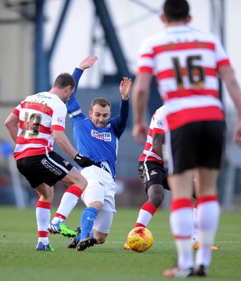 fit again: Liam Kelly tries to cut out a pass by Doncaster Rovers midfielder Richie Wellens. PICTURE by ALAN HOWARTH