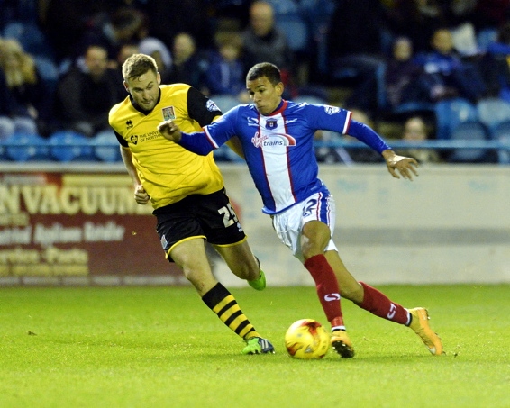 TASTE OF THE ACTION: Connor Brown (right) stretches out for Carlisle against Northampton.