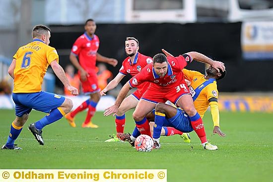 GET OUT OF MY WAY . . . Athletic forward Michael Higdon brushes aside a Mansfield Town opponent in the goalless draw at Field Mill. PICTURES by ALAN HOWARTH.