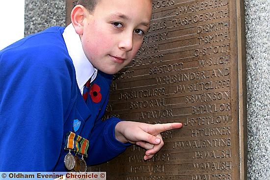 Shaw Remembrance Sunday. Leo Baker, house captain at Crompton primary school, points to his Great Great Grandfathers name , J.F. Tetlow, who fell at the Battle of the Somme, during the Great War. 