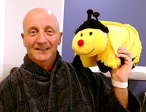 IN good spirits . . . David with his lucky mascot after his operation