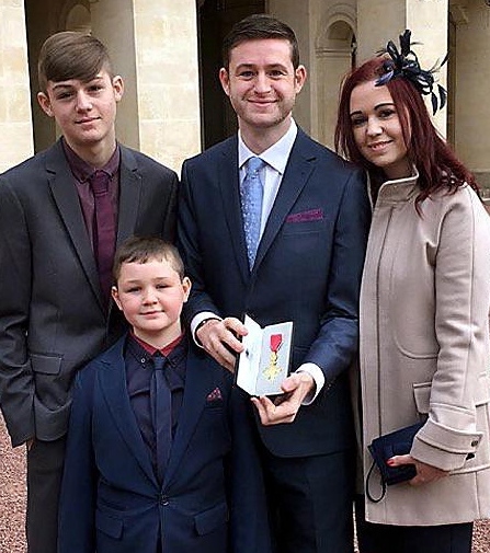Jim McMahon and his family with the OBE