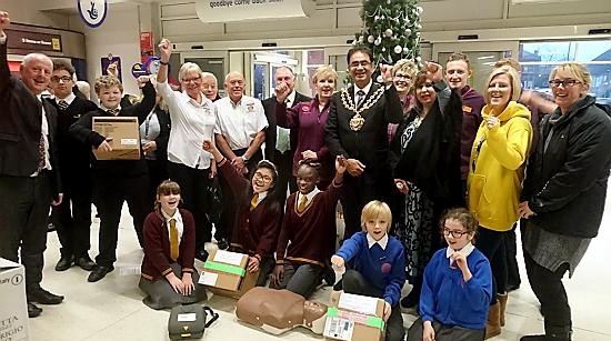 LIFESAVERS . . . Oldham Mayor, Councillor Ateeque Ur-Rehman, presents the defibrillators at Sainsbury’s