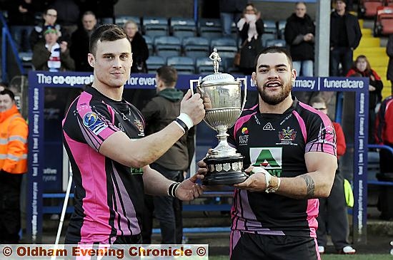 FLASHBACK . . . to February, 2013 at Spotland. Oldham’s Lewis Palfrey (left) and Sammy Gee show off the Law Cup after their team’s victory over Rochdale.