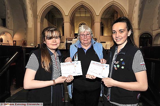 Sarah Bailey (l) and Katie Hardman-Elliot with their Baden Powell Award certificates and 46th Oldham St Anne’s guide leader Diane Jones
