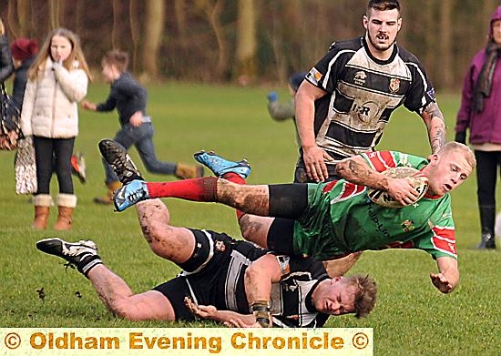 Waterhead's Jason Andrews is tackled by Saddleworth's Ben Whitehead