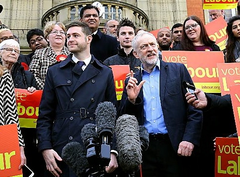 Labour party leader Jeremy Corbyn and new Labour MP Jim McMahon at a rally outside Chadderton Town Hall with party supporters on Friday, after Labour held the parliamentary by-election seat in Oldham West and Royton with a majority of 10,722