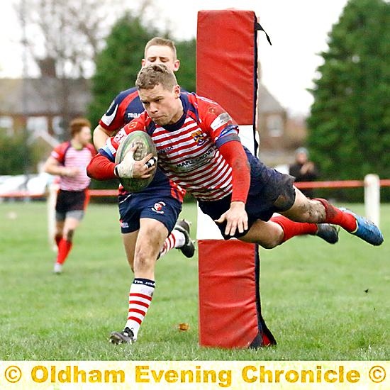 HIGH FLYER . . . Oldham’s Will Mellor dives over to score a try. 