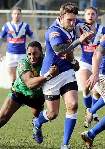 OLDHAM's Michael Laurence gets his hands on Raiders’ Peter Lupton.