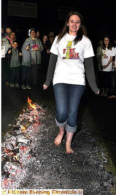BEST hot foot forward: Reporter Lucy walks over hot coals. Picture: PAUL STERRITT