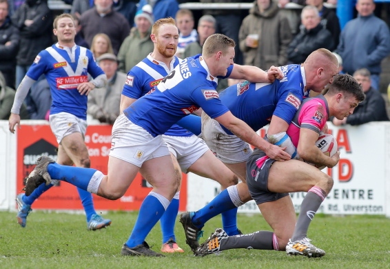 GROUNDED: Oldham’s Jack Holmes has men at his back.