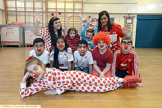 ONESIES, wigs, football shirts and funny wigs were on the timetable when pupils at Knowsley Primary School ditched their usual uniforms for Red Nose Day. Darcey Graham (front) is pictured with fellow pupils and staff.