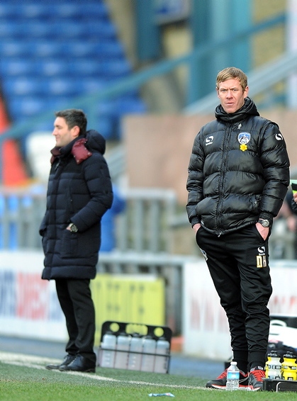 BEST OF ENEMIES: former colleagues Dean Holden (right) and Lee Johnson look on from the touchline on Saturday.