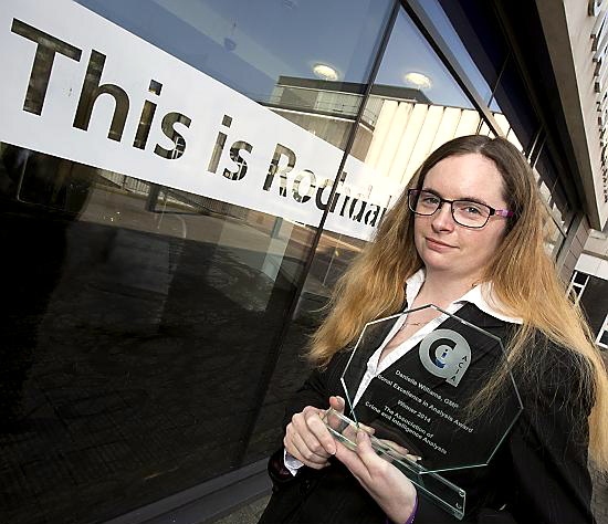Intelligence analyst Danielle Williams with one of her awards.
