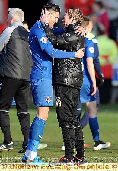 YOU’RE THE MAN: Dean Holden (right) embraces goal hero Conor Wilkinson after victory over Crewe. 