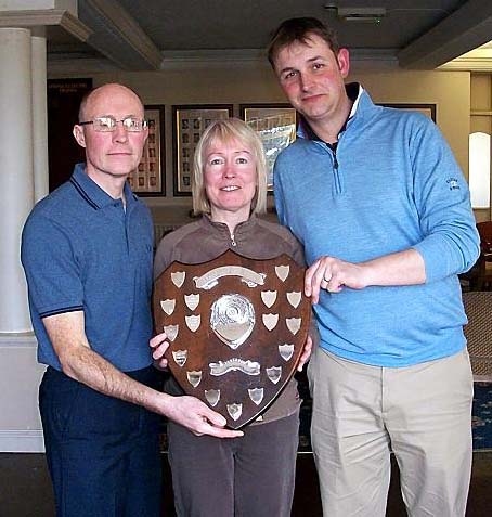 ALL YOURS . . . David and Dee Whittingham receive their trophy from Werneth professional James Matterson (right).