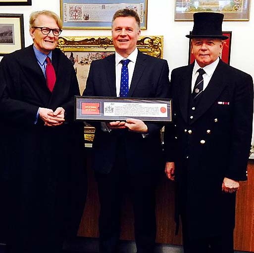 Nick Howard (centre) receives his award from officials at a ceremony where he was given the Freedom of the City of London