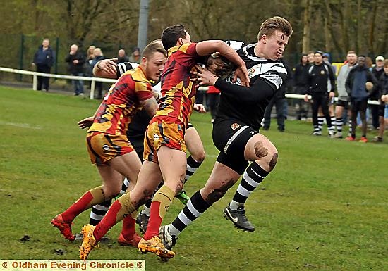 GET BACK: Ben Whitehead, of Saddleworth Rangers, pushes away a Shaw Cross Sharks challenge. 