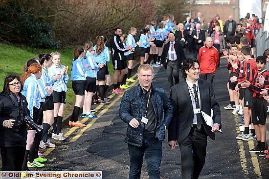 Paul Scholes walks to the pitches with head teacher Karl Newell