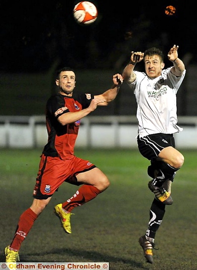Mossley’s Josh Granite (right) looks to win a header against Bamber Bridge last night. PICTURE by DARREN ROBINSON