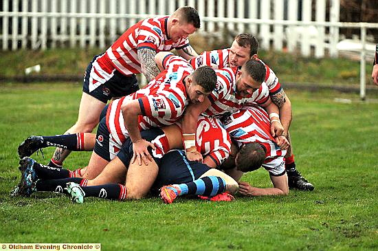 SIX Oldham players pounce on an unfortunate Coventry Bears rival during yesterday’s clash at Whitebank. 
