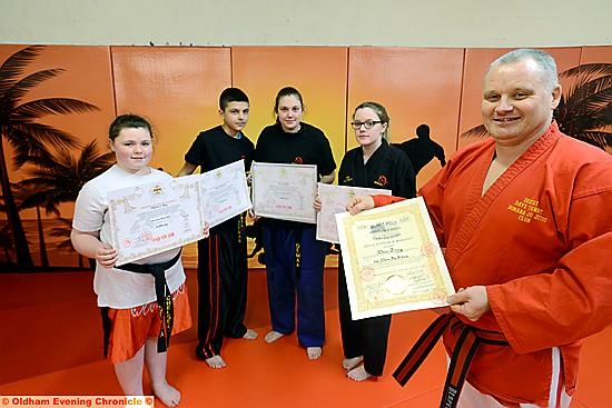 PROUD SMILES . . . DEMAA Martial Arts instructor Dave Terry (right) is pictured with (from left): Chelsea Hoy (first dan), Sohail Mahmood (second dan), Amy Sutcliffe (first dan) and Lucy Haslam (second dan).
