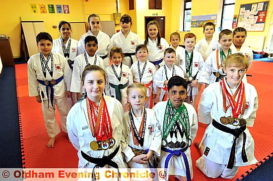 MEDAL MANIA: members of Kenny Karate Club, who struck gold, silver and bronze in recent competitions. Pictured are Katelyn Entwistle (left), Erin Joyce, Jamal Akhtar, Rosy Whittle and other medal winners behind.