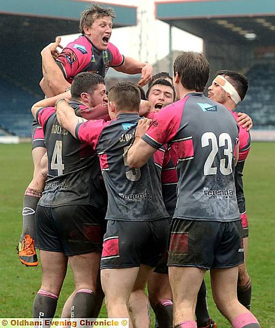 HUGS BETTER . . . Oldham players celebrate after Josh Crowley’s match-winning try (below, left).