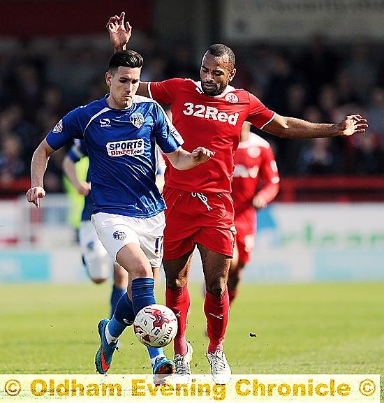 RUNNING BATTLE: Conor Wilkinson tries to beat a Crawley rival.