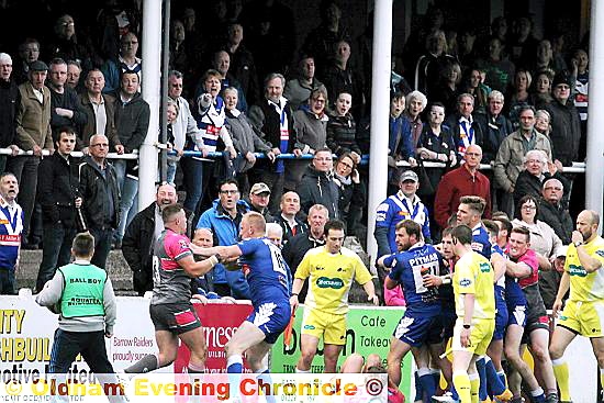 TOUCHLINE TEMPERS . . . the home crowd get a close-up view as Barrow and Oldham players square-up in the later stages of a fiercely-contested Kingstone Press League One clash at Craven Park. PICTURE by DAVE MURGATROYD