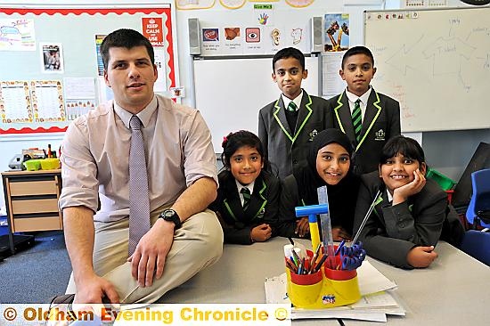 Teacher Craig Windslow in his classroom at Werneth Primary School. He is also an army reservist. Pupils (back) L-R: Faisal Sajjad and Fahad Yaseen.

Front: Anisha Taher, Sumayyah Khatun, Niabah Iman.