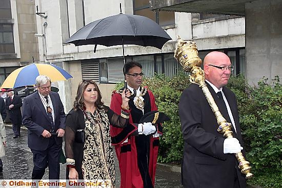 Oldham’s new Mayor Councillor Ateeque Ur-Rehmanand Mayoress Councillor Yasmin Toor avoid the rain.