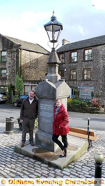 BACK to its best . . . Dobcross Village Community chair Pamela Rose with vice chair Paul Clegg at the restored memorial. 
