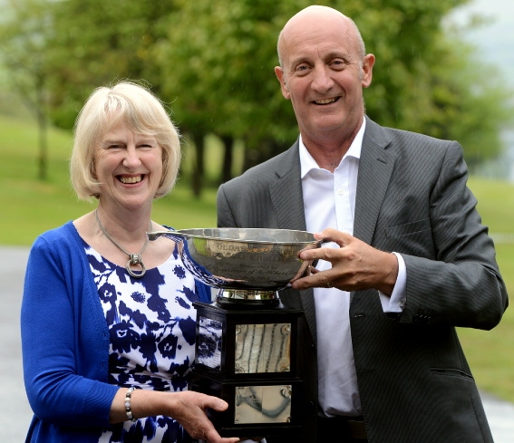 Eileen Simpson receives the cup from the Chronicle's David Whaley